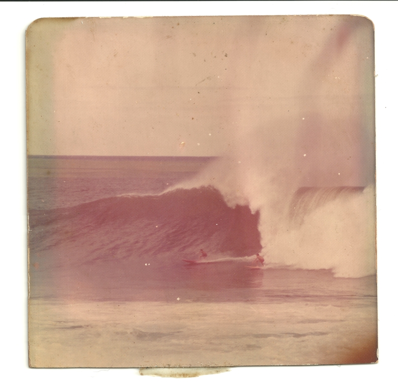 Original scan. Unprocessed image. James MacLaren at Waimea Bay, Hawaii, 1973, photo by Billy Amell. You tend to remember this kind of stuff with surprising clarity for a lifetime, and I distinctly recall that the guy behind me did not make this wave, although it looks like he’s got a pretty good shot at it. The angle these photos were taken from is deceptive, because it looks like you're directly in front of things, looking straight at the wave as it comes right at you, but you are not. You are standing in somebody's back yard over toward the end of the point, and are looking more than just a little bit lengthwise along the line of the wave, from behind, and both riders in the frame are traveling in a direction significantly more "toward the beach" than the "down the line" direction this photo would give you to believe that they are traveling in. Bottom line: The safety of the channel, out on the shoulder of the wave, isn't nearly as "reachable" as the image makes it look. Original scan. Unprocessed image. James MacLaren at Waimea Bay, Hawaii, 1973, photo by Billy Amell. You tend to remember this kind of stuff with surprising clarity for a lifetime, and I distinctly recall that the guy behind me did not make this wave, although it looks like he’s got a pretty good shot at it. The angle these photos were taken from is deceptive, because it looks like you're directly in front of things, looking straight at the wave as it comes right at you, but you are not. You are standing in somebody's back yard over toward the end of the point, and are looking more than just a little bit lengthwise along the line of the wave, from behind, and both riders in the frame are traveling in a direction significantly more "toward the beach" than the "down the line" direction this photo would give you to believe that they are traveling in. Bottom line: The safety of the channel, out on the shoulder of the wave, isn't nearly as "reachable" as the image makes it look.